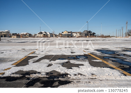 Snow covered parking lot with the lines covered in some locations. Snow covered parking lot with the lines covered in some locations. 130778245