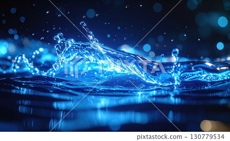Vibrant blue water splash with dynamic movement and illuminated droplets creating a lively aquatic scene in a dark background 130779534