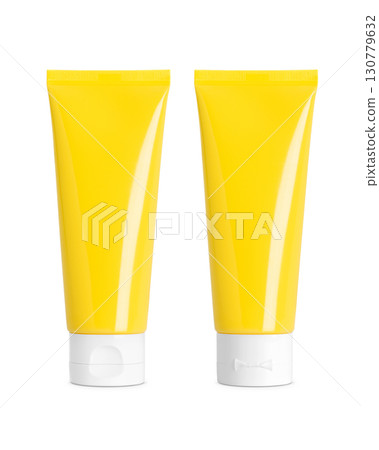 Yellow plastic cosmetic tubes with white flip caps, front and back view on white background, clean packaging mockup 130779632