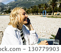 mature woman working outside in caffe on beach coast, lifestyle people concept 130779903