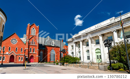 The historic red brick First United Methodist Church stands beside the classical architecture of City Hall on a sunny day in Pittsfield, Massachusetts, USA 130780212