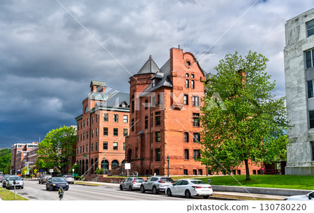 Historic Richardsonian Romanesque building with conical tower and arched entry on State Street near the Vermont State House in Montpelier, United States 130780220