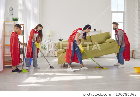Happy smiling family with children in super heroes costumes cleaning floor together at home. Happy smiling family with children in super heroes costumes cleaning floor together at home. 130780365