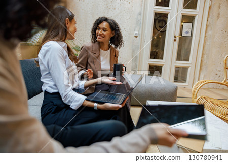 Professional Women Collaborating Effectively in a Modern and Inviting Workspace Environment Professional Women Collaborating Effectively in a Modern and Inviting Workspace Environment 130780941