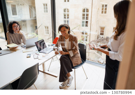 Collaborative Business Meeting Held in a Contemporary Office Space Designed for Efficiency 130780994