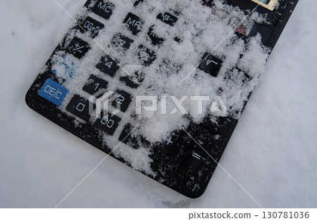 Powder Snow Covers The Front Panel With Square Buttons Of Rare Solar-Powered Calculator. Concept image for illustration of financial problem  130781036