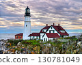 The historic Portland Head Light in Cape Elizabeth, Maine, USA. The landmark lighthouse is situated on a rocky cliff overlooking the Atlantic Ocean at sunset 130781049