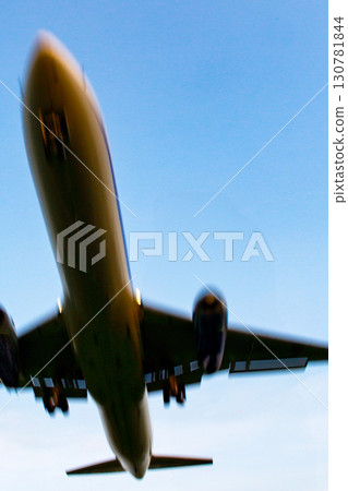 A landing plane with a slight blur to give it a sense of speed 130781844