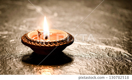 Single Clay Diya on Black Marble Surface. Diwali Festival Concept. Generated Image 130782518