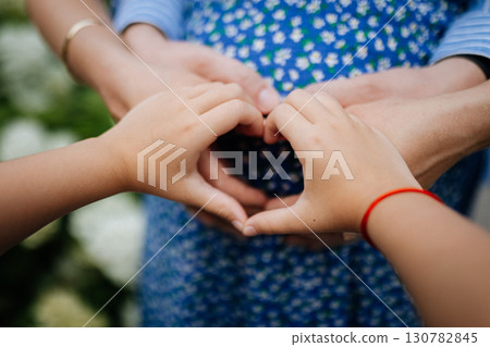 Hands making heart on pregnant belly , family waiting for a new baby with love 130782845
