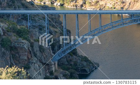 Majestic Steel Bridge Spanning Rocky Canyon River Majestic Steel Bridge Spanning Rocky Canyon River 130783115