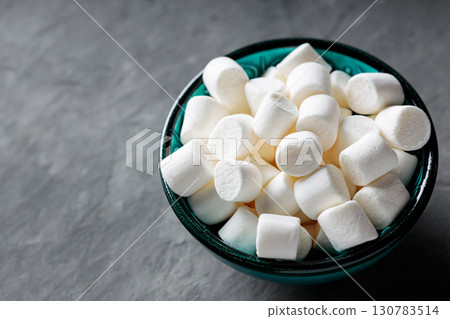 White Marshmallows in Turquoise Bowl on Gray Concrete Surface White Marshmallows in Turquoise Bowl on Gray Concrete Surface 130783514