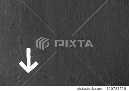 A white arrow on a gray wall with space for text 130783716