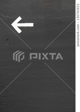 A white arrow on a gray wall with space for text 130783833