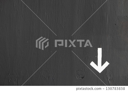 A white arrow on a gray wall with space for text 130783838