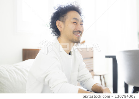 man in living room man in living room 130784302