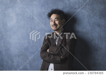 smiling man in suit 130784385