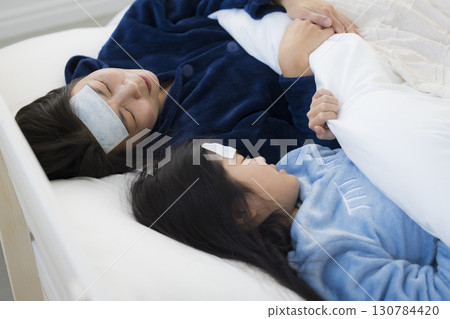 A mother and a girl with a fever A mother and a girl with a fever 130784420