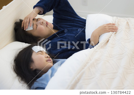 A mother and a girl with a fever 130784422