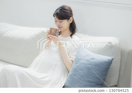 pregnant woman in the living room pregnant woman in the living room 130784525