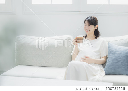 pregnant woman in the living room 130784526