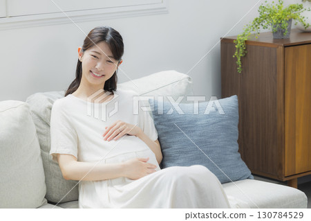 pregnant woman in the living room 130784529