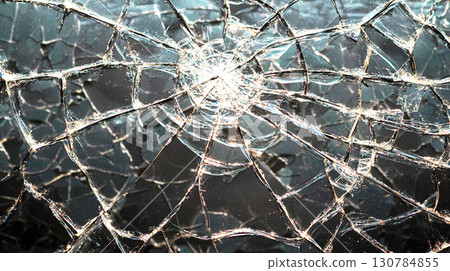 Shattered glass crack texture on dark background 130784855
