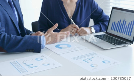 Businessman and business woman reviewing financial documents, collaborating over laptop screen, analyzing market charts for strategic corporate planning. Businesspeople and finance concept Businessman and business woman reviewing financial documents, collaborating over laptop screen, analyzing market charts for strategic corporate planning. Businesspeople and finance concept 130785057
