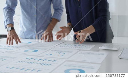 Professional team analyzing financial reports, sharing insights and planning strategic decisions in modern workplace setting. Business people concept Professional team analyzing financial reports, sharing insights and planning strategic decisions in modern workplace setting. Business people concept 130785177