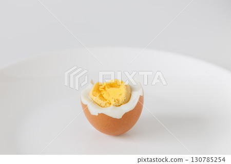Half boiled egg on a white plate Half boiled egg on a white plate 130785254