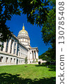 West Virginia State Capitol building in Charleston, West Virginia, United States. Designed by architect Cass Gilbert, the landmark is noted for its 23-karat gold-leaf dome, seen here framed by tree 130785408