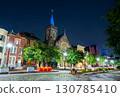St. Lawrence Catholic Church, a historic Gothic Revival church on a street in Harrisburg, Pennsylvania, USA. The building is illuminated at night with a blue spire 130785410