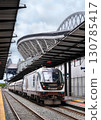 Seattle, Washington - June 22, 2025: An Amtrak Cascades passenger train at the King Street Station platform. Lumen Field, a major sports stadium, is visible in the background 130785417