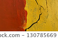 Cracked yellow and red wall showing rustic texture 130785669
