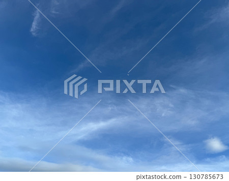 Blue sky with scattered white clouds in natural daylight Blue sky with scattered white clouds in natural daylight 130785673
