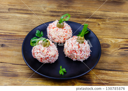 Appetizer of crab-cheese balls made in a shape of Christmas baubles on wooden table Appetizer of crab-cheese balls made in a shape of Christmas baubles on wooden table 130785876