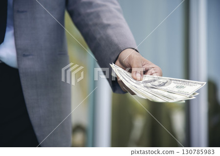 Hand holding loan money dollar bank note give financial payment. Man hands showing spread 100 dollar exchange cash payout. Saving Businessman counting money banknote  bribe corruption concept. 130785983