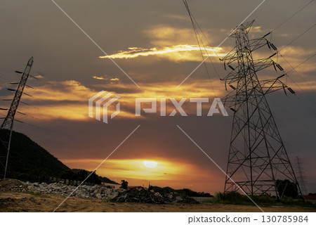 High voltage pole electric wiring distribution landscape energy engineering. Electricity energetic background with blue sky green mountain in countryside. Electric power energy engineering industrial High voltage pole electric wiring distribution landscape energy engineering. Electricity energetic background with blue sky green mountain in countryside. Electric power energy engineering industrial 130785984