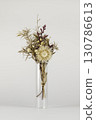 Dried flowers in a transparent vase on a white background 130786613