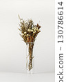 Dried flowers in a transparent vase on a white background 130786614