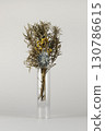 Dried flowers in a transparent vase on a white background 130786615