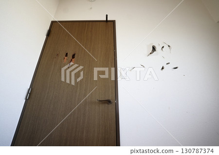 Holes in the wall and door 130787374