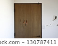 Door and wall with holes 130787411