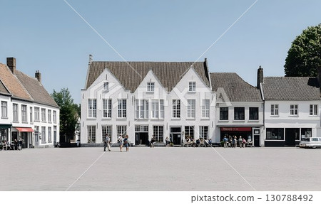 Quaint European Town Square with White Buildings and Outdoor Caf 130788492