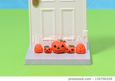 A ghostly pumpkin placed in front of the front door (Halloween) 130790209
