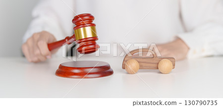 Car Law, Insurance, auto Tax, Auction and Bidding concepts. Wood small toy car models with Judges gavel on desk in courthouse. Car Law, Insurance, auto Tax, Auction and Bidding concepts. Wood small toy car models with Judges gavel on desk in courthouse. 130790735