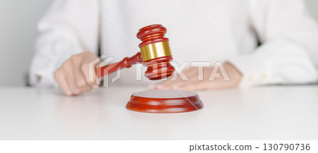 Woman Hand hold judge gavel. Law, lawyer, judgment, justice auction and bidding concept Woman Hand hold judge gavel. Law, lawyer, judgment, justice auction and bidding concept 130790736