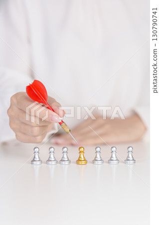 Hand point dart to golden chess pawn pieces or leader businessman stand out of crowd people of silver men. leadership, business, team, teamwork, unique and Human resource management concept Hand point dart to golden chess pawn pieces or leader businessman stand out of crowd people of silver men. leadership, business, team, teamwork, unique and Human resource management concept 130790741