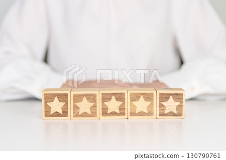 hand show Star block. Customer choose rating for user reviews. Service rating, ranking, customer review, satisfaction, evaluation and feedback concept hand show Star block. Customer choose rating for user reviews. Service rating, ranking, customer review, satisfaction, evaluation and feedback concept 130790761