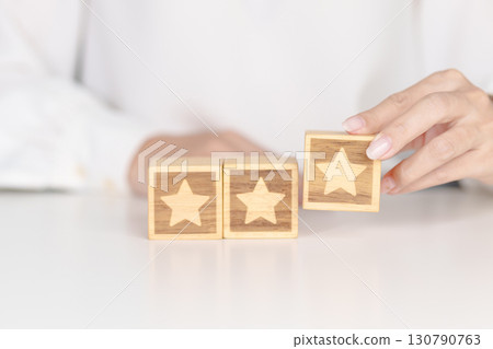 hand show Star block. Customer choose rating for user reviews. Service rating, ranking, customer review, satisfaction, evaluation and feedback concept hand show Star block. Customer choose rating for user reviews. Service rating, ranking, customer review, satisfaction, evaluation and feedback concept 130790763